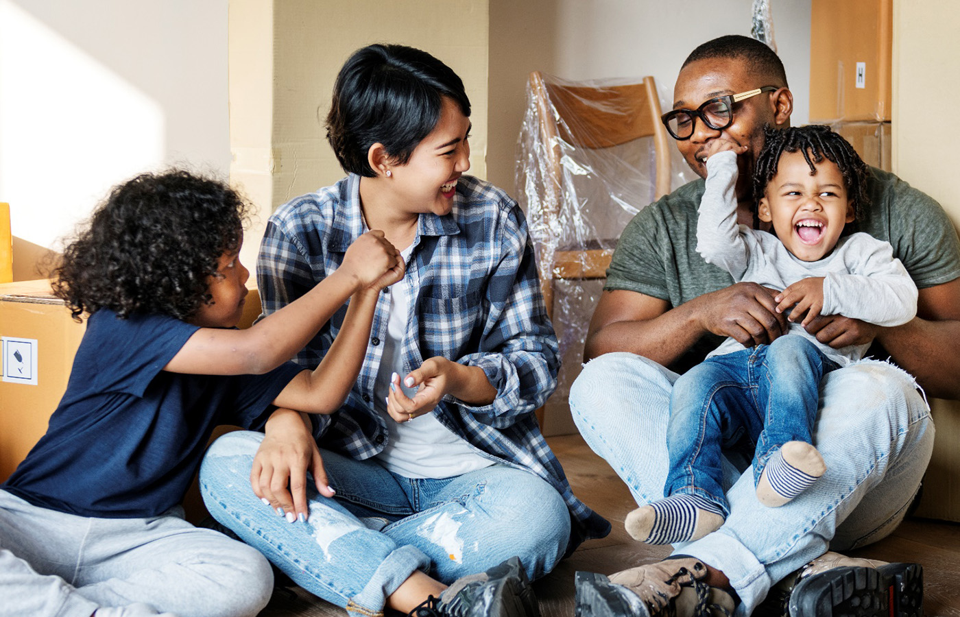Image of a happy family in a new home. Photo Credit: raqpixel / iStock